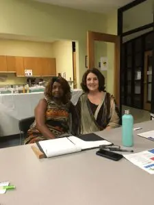 Two women sitting at a desk